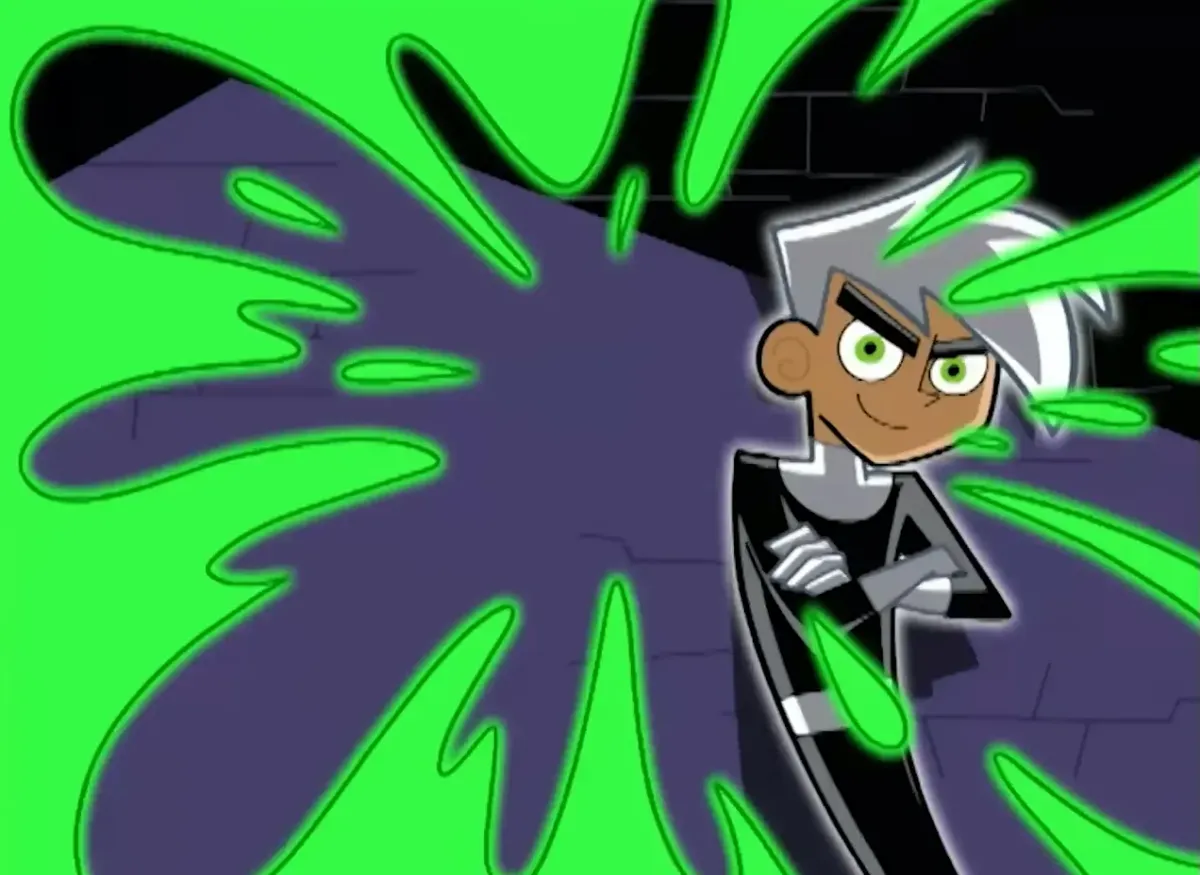 A screencap from the opening credits of Danny Phantom, with green glowing slime and a ghost boy in an action pose.