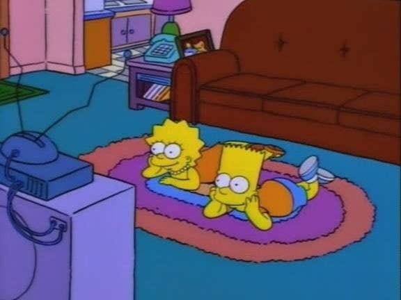 A screencap of Lisa and Bart watching TV from an older episode of The Simpsons